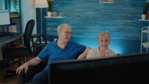 Older couple enjoying their favorite shows on the best smart TV for seniors